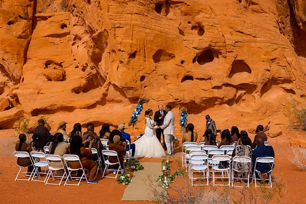 Wedding ceremony at the Seven Sisters with white guest chairs and red rock behind, Valley of Fire State Park